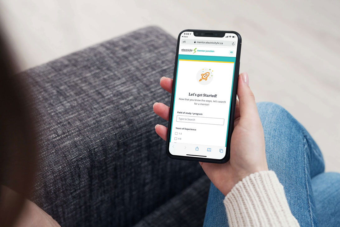 Person holding smartphone displaying a web app