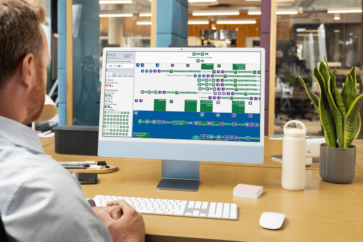 Man looking at a computer screen that is open to a page from wave tool.